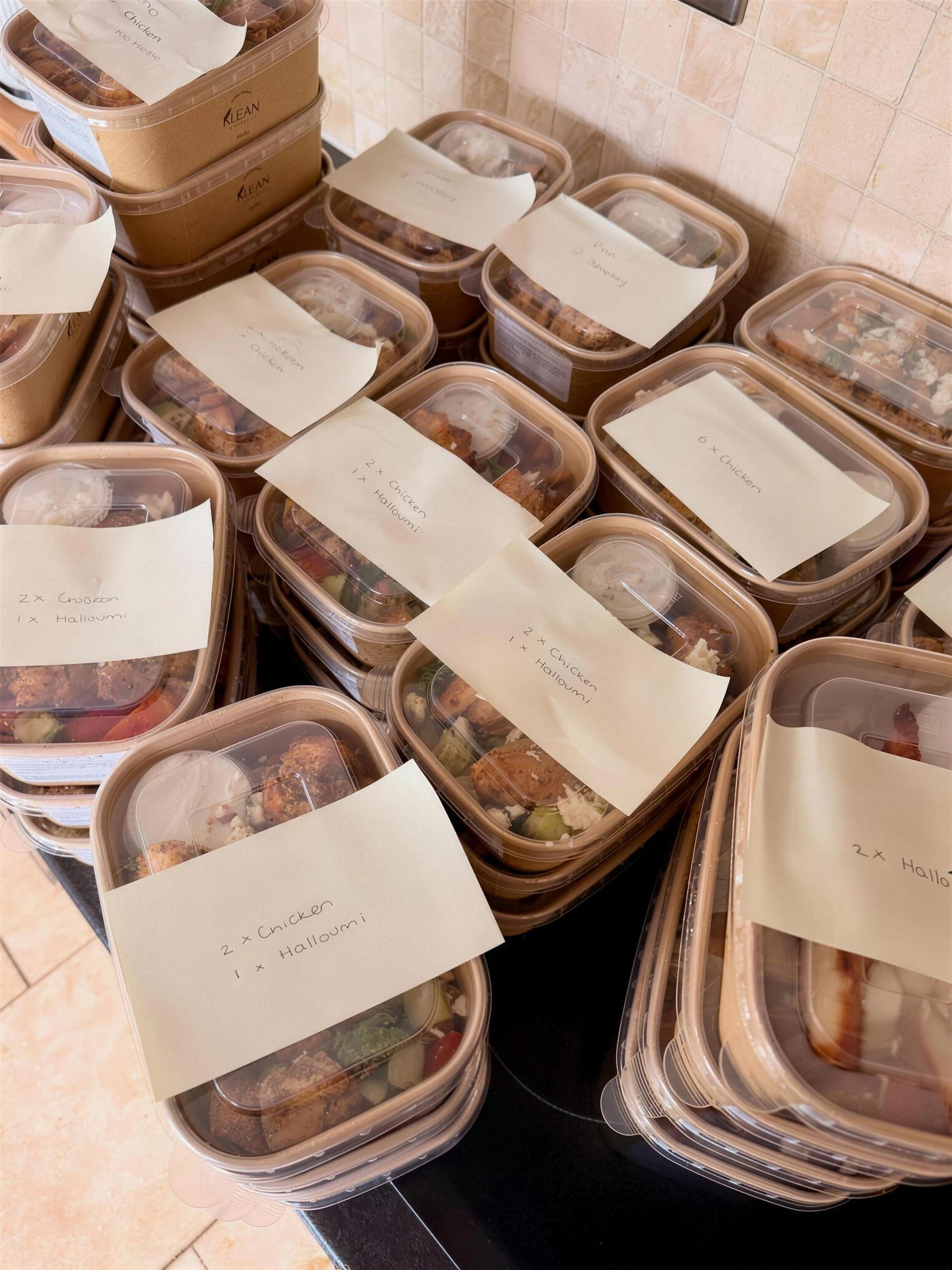 Labelled Klean Kitchen boxes stacked for collection